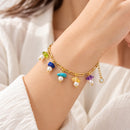 Pulsera dorada con piedras multicolor y perlas